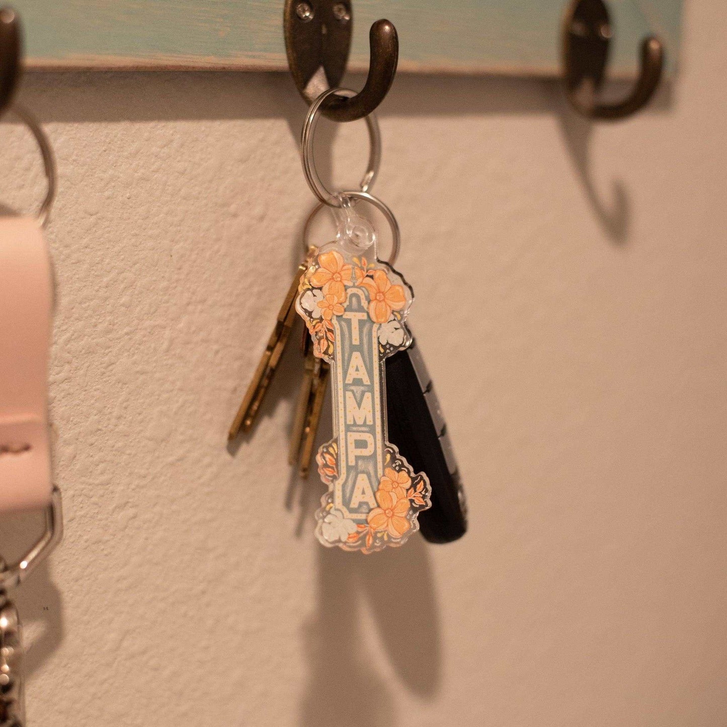 Acrylic keychain featuring Tampa, Florida sign with floral design, on a key ring.