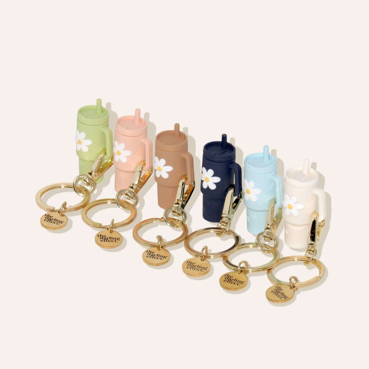 Tiny Tumbler Keychain in pink with flower detail and gold keychain.