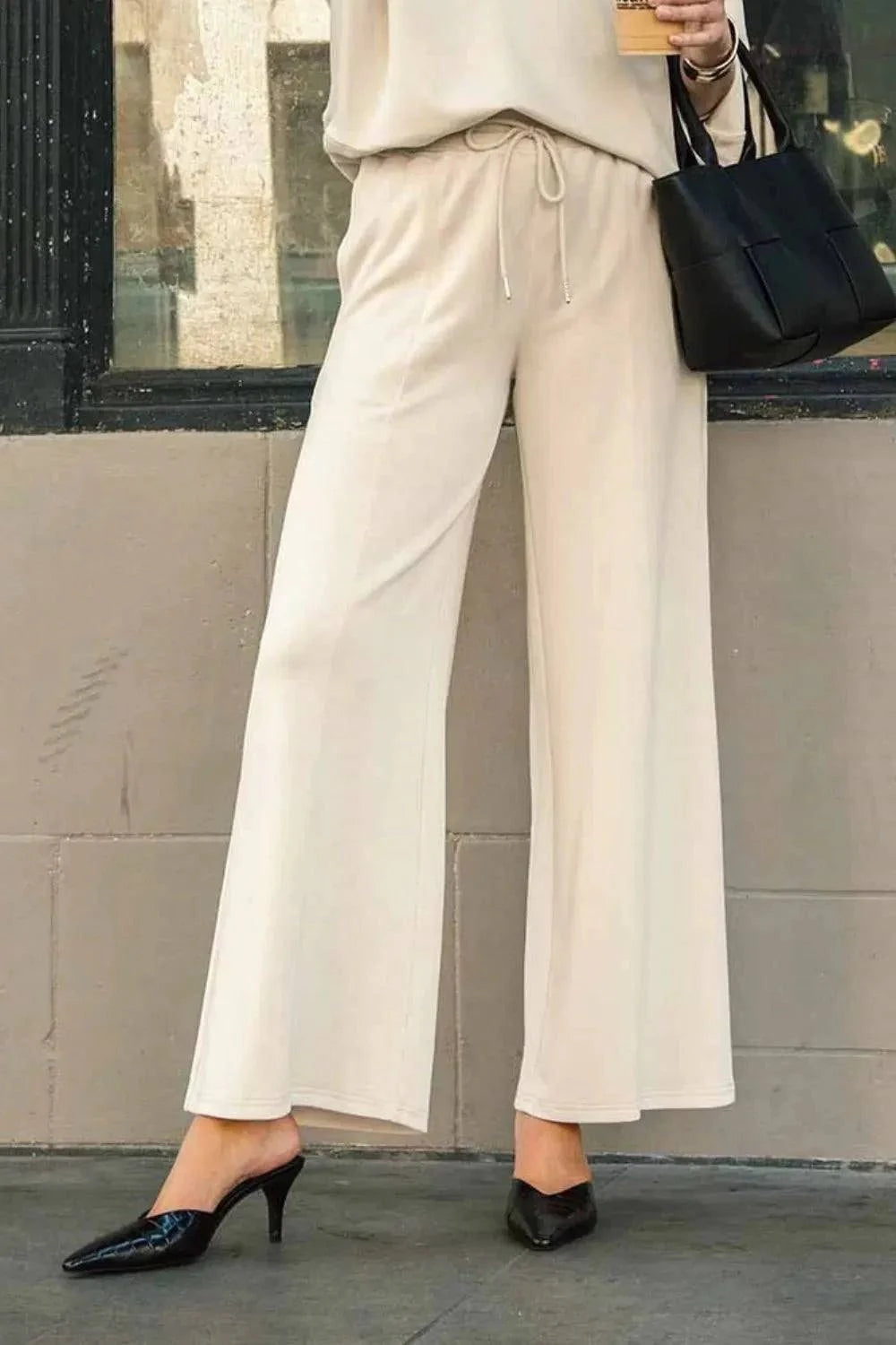 Drawstring wide leg pants with pockets in cream, stylish and versatile for casual or sophisticated looks.