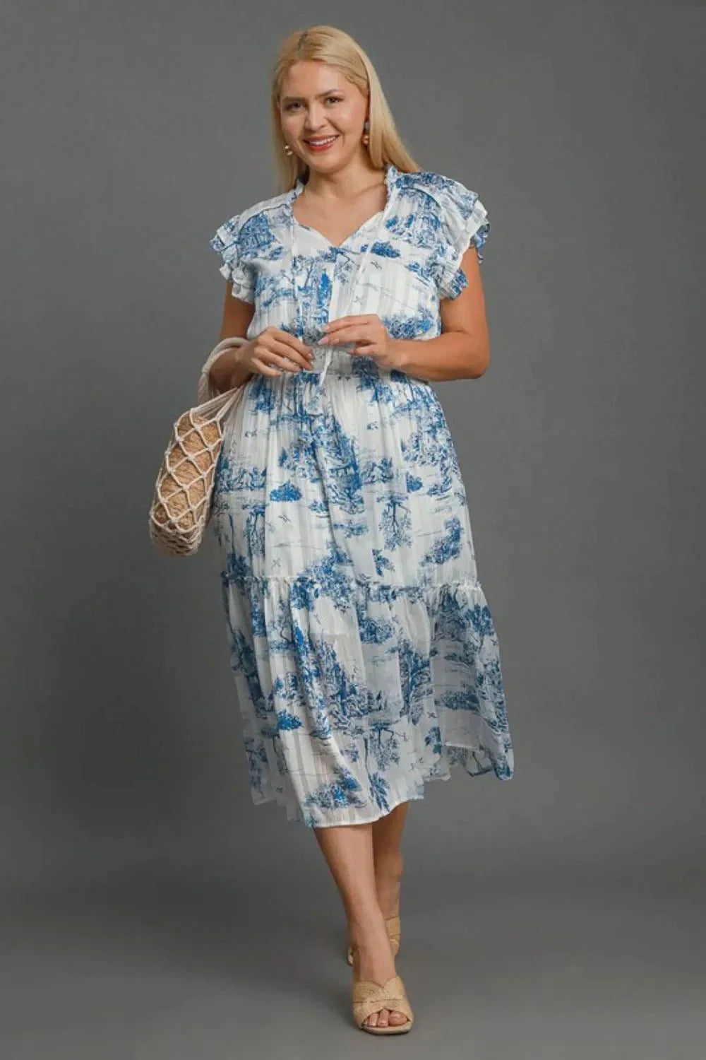 Umgee two tone landscape print midi dress with ruffled sleeves, styled elegantly on model.