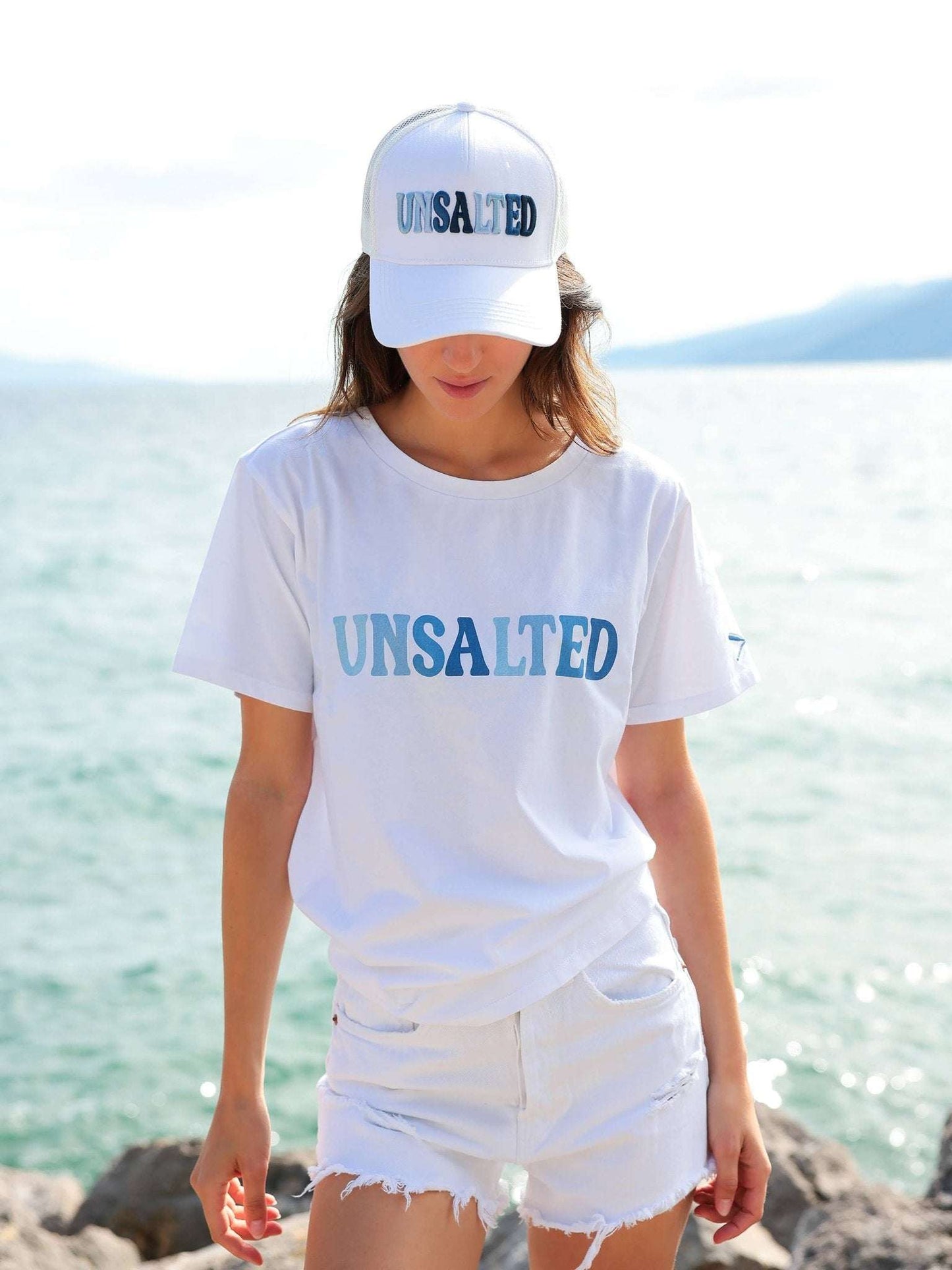 Lake Life Trucker Hat with "Unsalted" ombré blue embroidery, adjustable snapback, white panels, and mesh back.