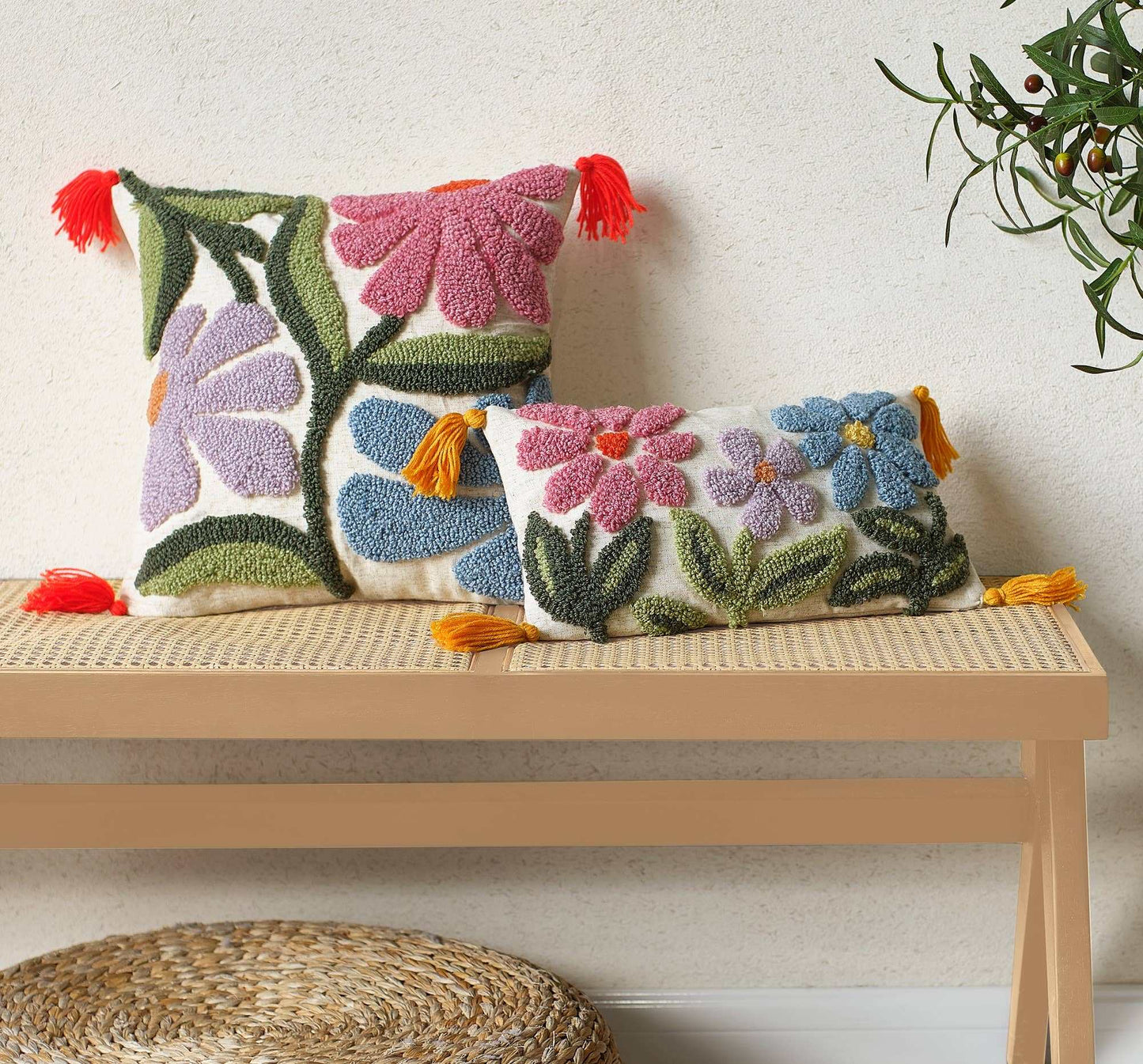 Wavy Floral Field tufted pillow with tassels on a bench.