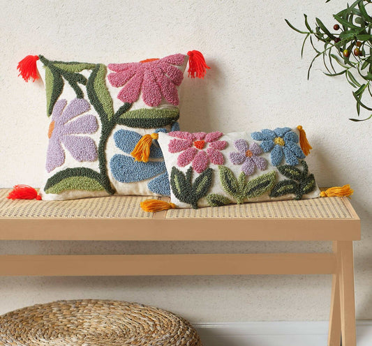 Wavy Floral Field tufted pillow with tassels on a bench.