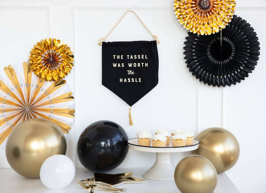 Worth the Hassle Canvas Banner for graduation celebration decor with cupcakes and balloons.