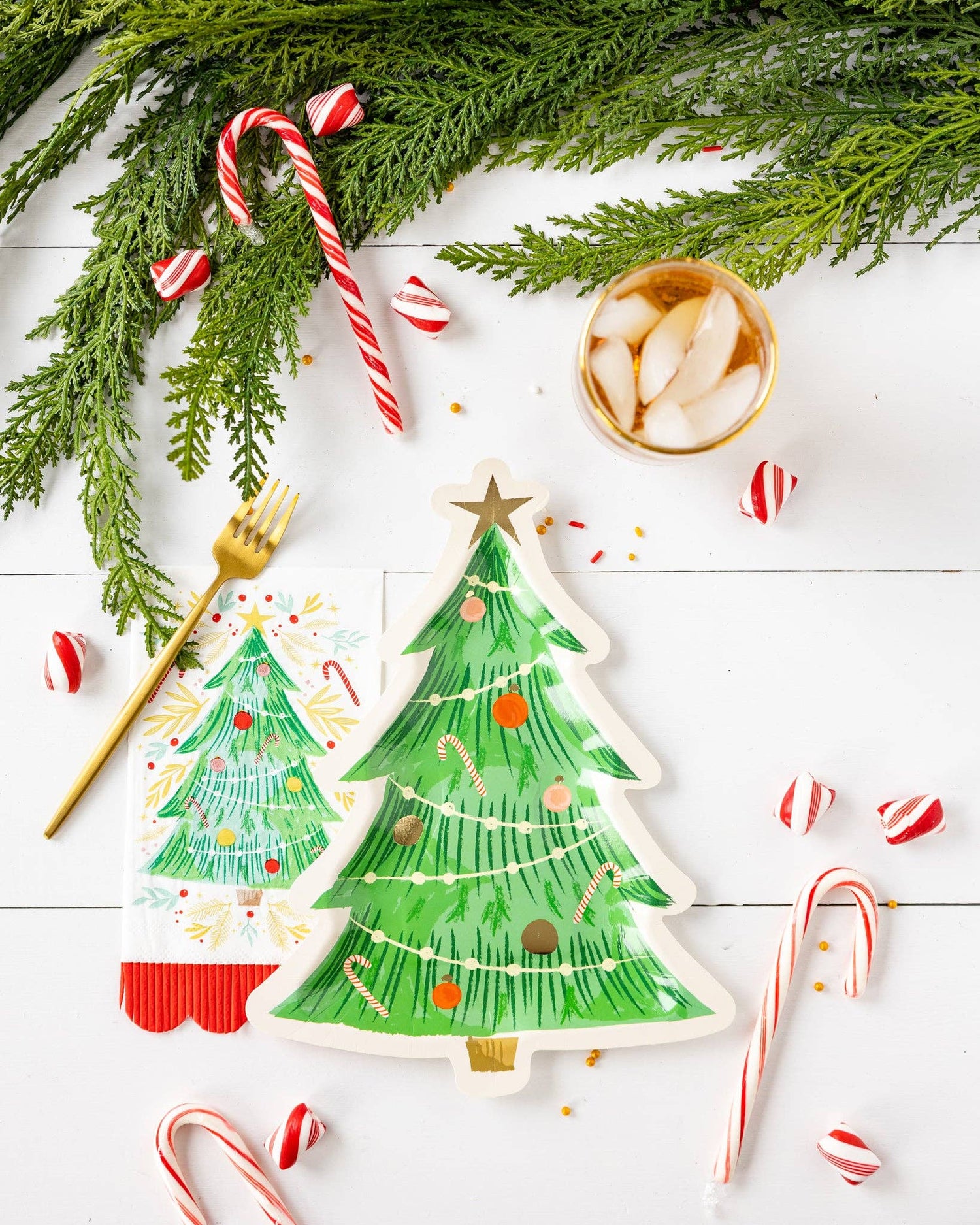 Holiday Papergoods featuring festive Christmas tree plates, candy canes, and holiday decor.