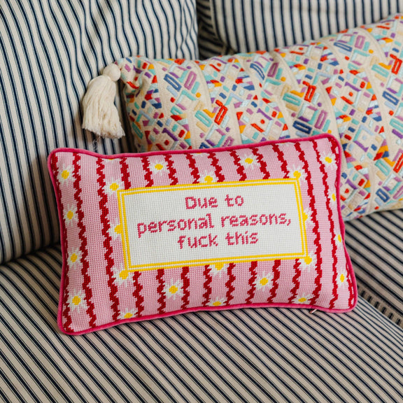 Decorative pillow with text on a striped couch