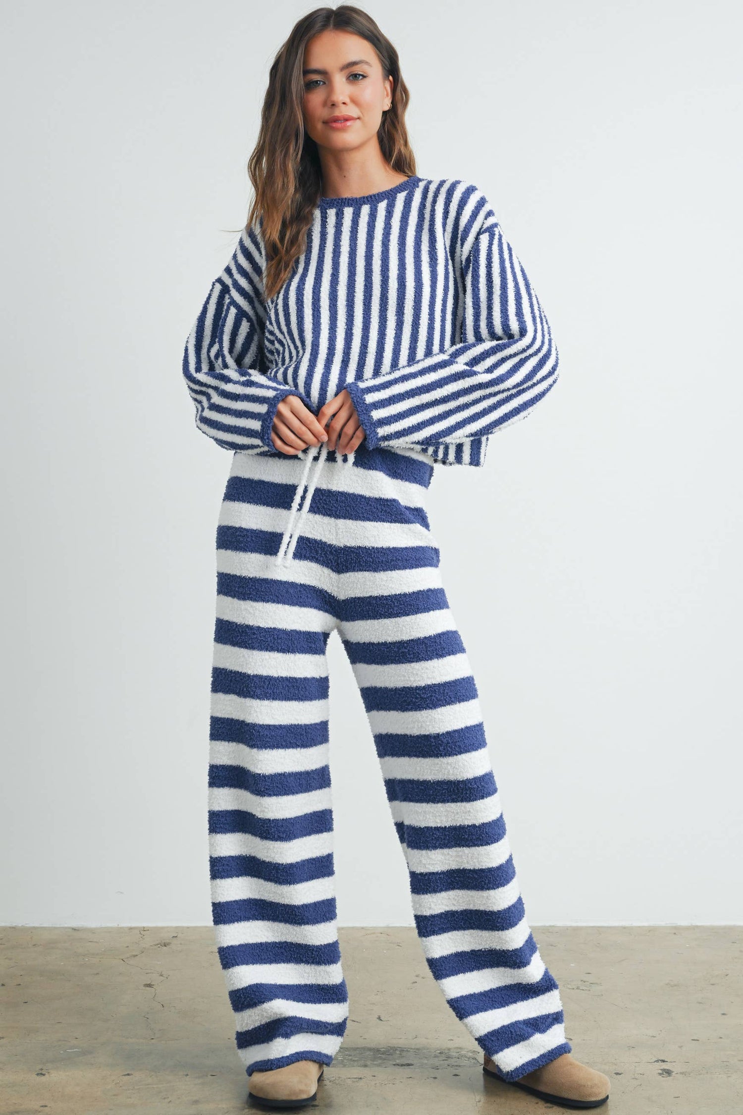Model wearing Buttermelon Striped Drawstring Lounge Pants with matching sweater, showcasing stylish vertical stripes.