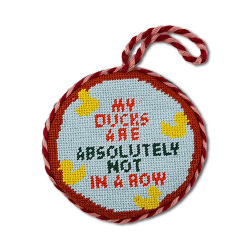Needlepoint ornament ducks in a row featuring playful ducks and humorous text for holiday decor.