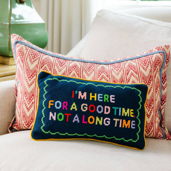 Decorative pillow with colorful text on a couch