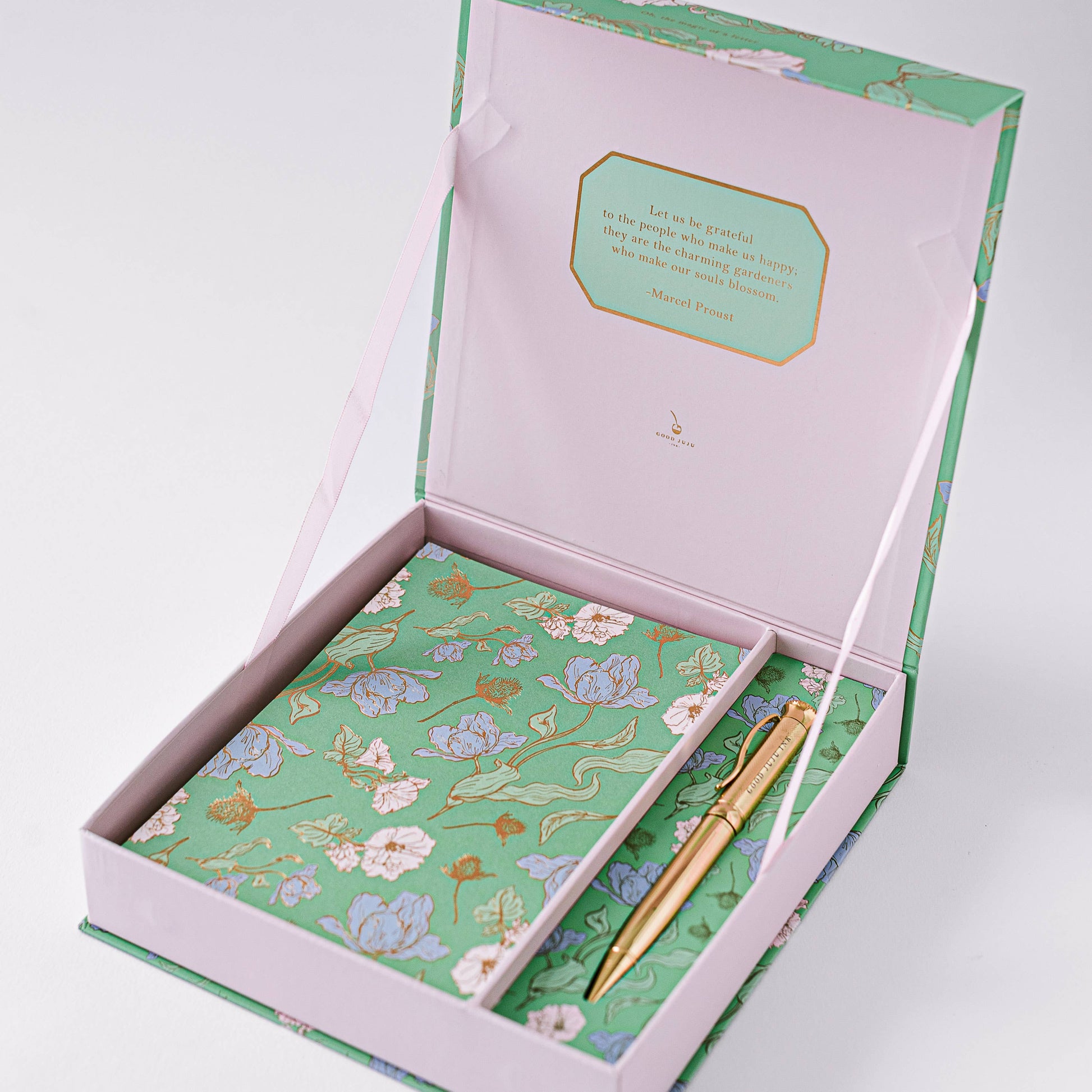 Good Juju Ink luxury stationery set featuring a gold-foiled keepsake box, writing sheets, envelopes, and a gold pen.