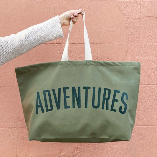 Olive green extra large canvas adventures bag with white handles, suitable for travel and outdoor activities.