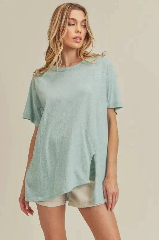 Aemi + Co asymmetrical front slit round neck raglan sleeve t-shirt in light green.