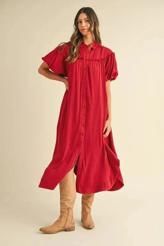Mineral washed button down puff sleeve shirt dress in red worn with boots.