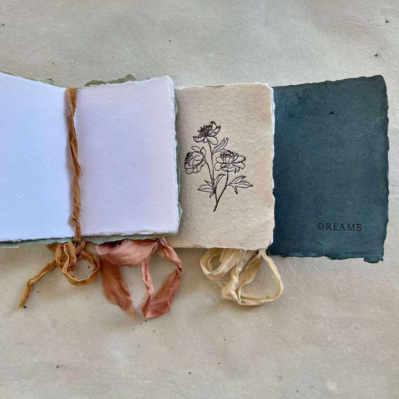 Artisan made small notebook with handmade cover, silk ribbon, and flower design, ideal for wedding vows and notes.
