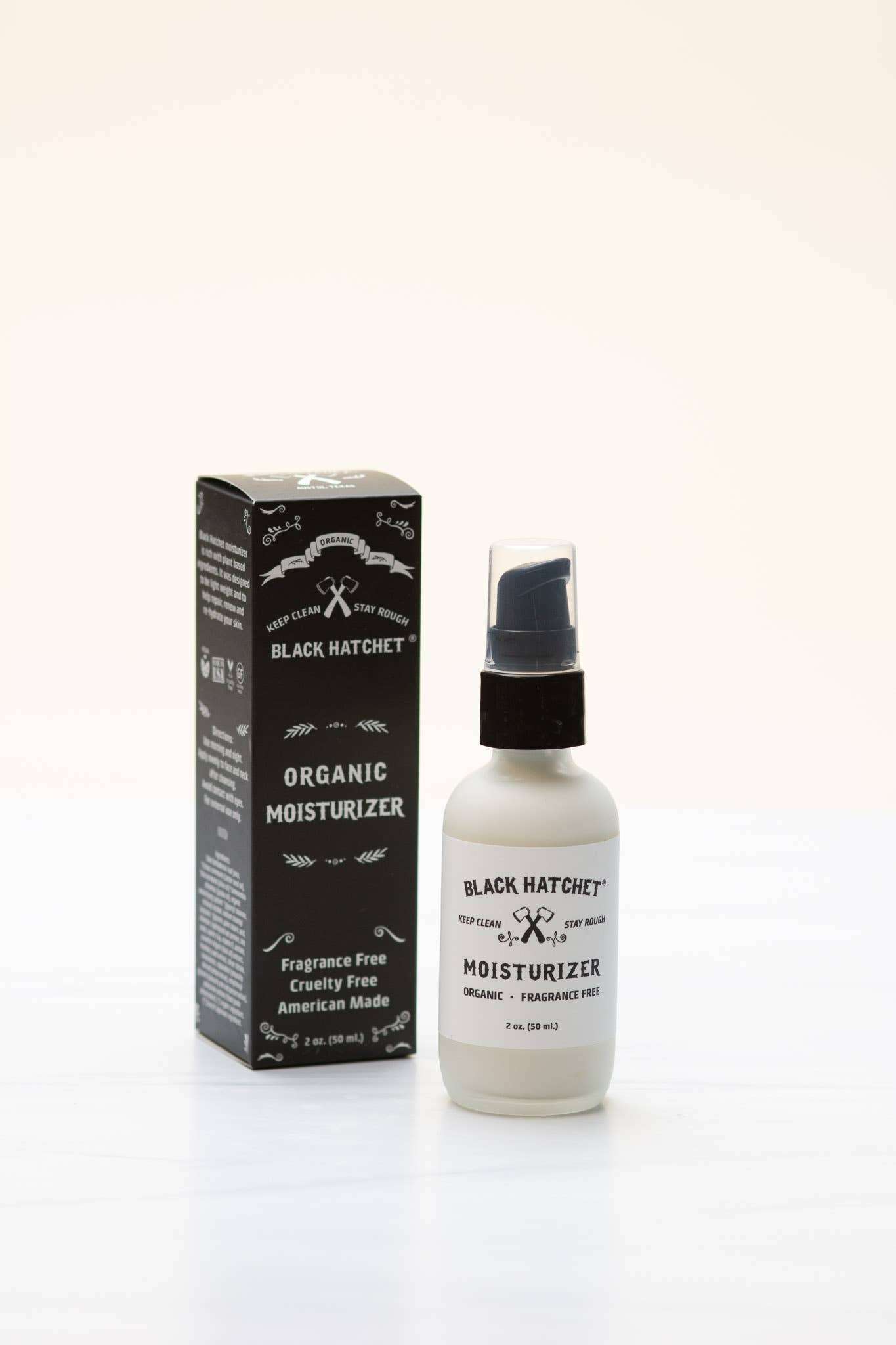 Black Hatchet Organic Moisturizer for Men in frosted glass pump bottle with packaging.