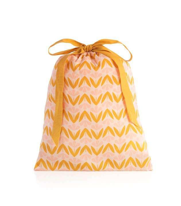 Blush Flora PJ Set in drawstring bag with floral pattern.