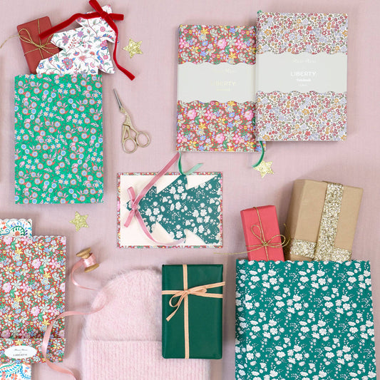 Various gift boxes with floral patterns on a pink background