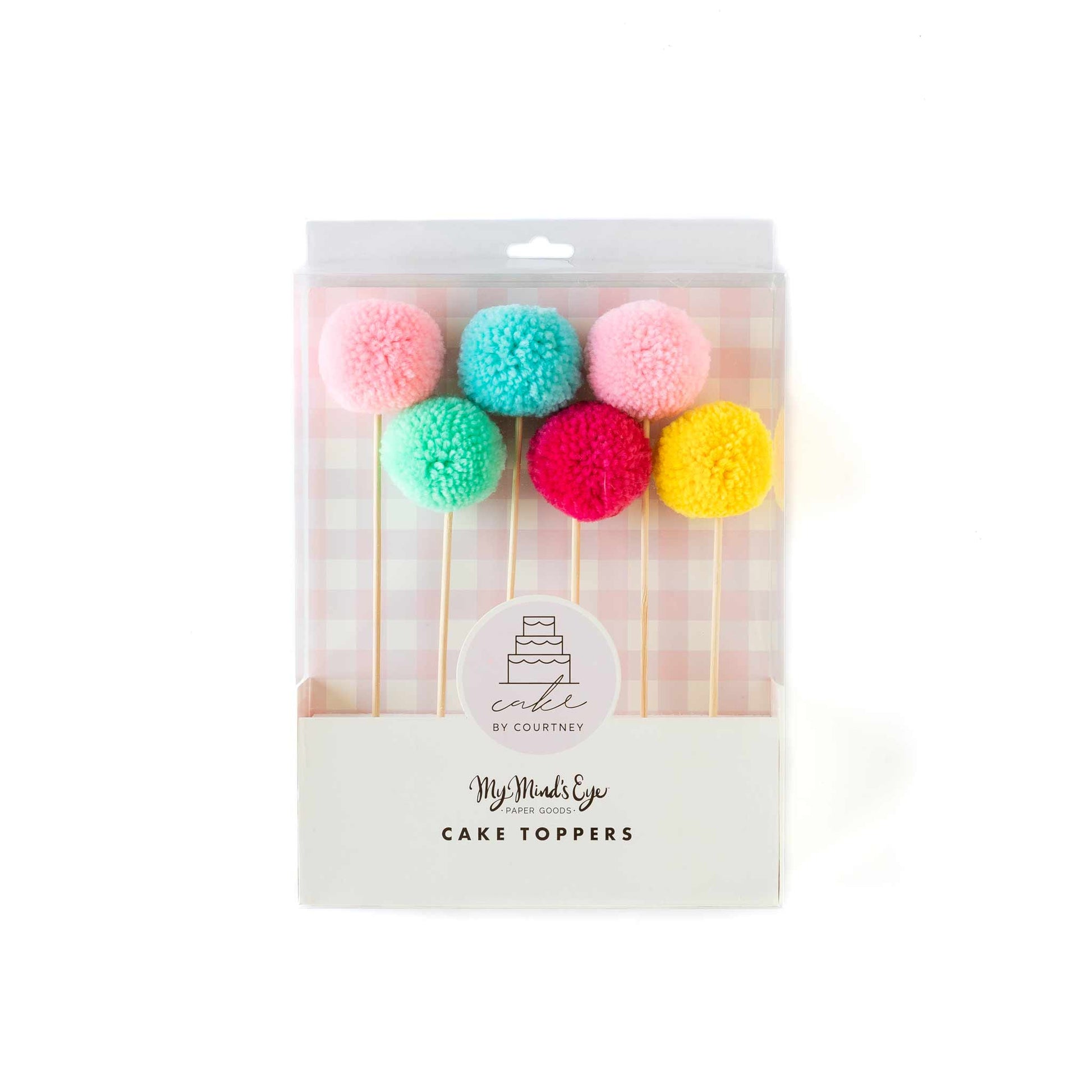 Cake By Courtney pom pom cake toppers in red, yellow, mint, blue, light pink, and dark pink.