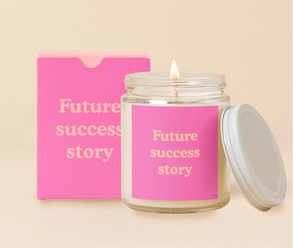 Candle Jar w/Lid featuring "Future Success Story" label, made of soy-based wax with cotton wick.