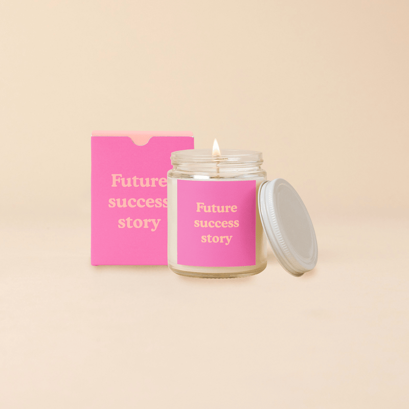 Candle jar with lid featuring "Future Success Story" label, soy-based wax, 8oz glass, 43-hour burn time.