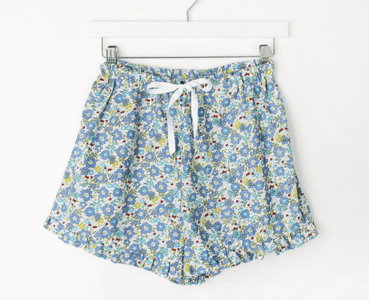 Charlotte Ruffle PJ Shorts with floral print, ruffled edges, elastic waistband, and ribbon tie.