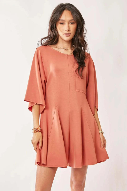 Davi & Dani coral pink skort romper with draped sleeves and chest pocket.