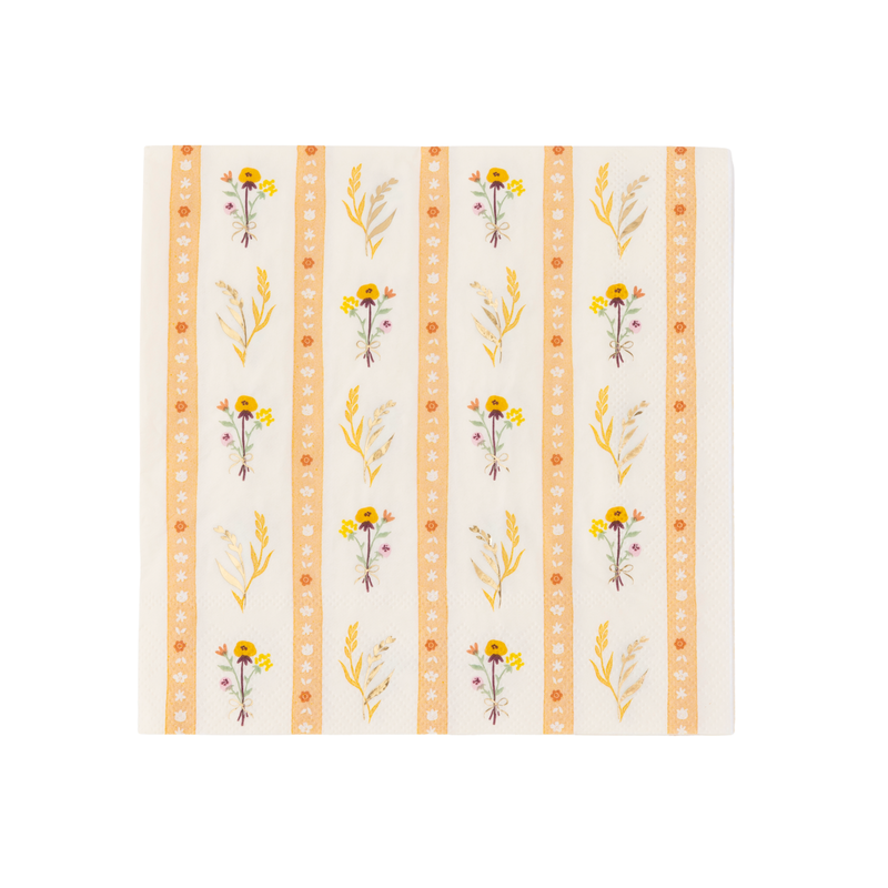 A square paper napkin featuring a vertical striped botanical pattern with yellow flowers, green leaves, and orange decorative borders on a cream background.