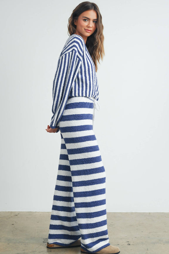Model wearing Buttermelon striped drawstring lounge pants showcasing a stylish, comfortable fit with vertical stripes.