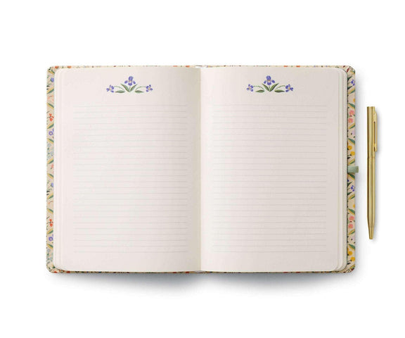 Rifle Paper Co. Estee Journal with Pen, open hardcover with floral design, ruled pages, and gold pen.