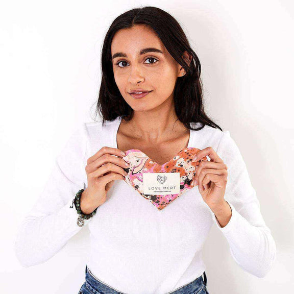 Heart-shaped Eye Love Pillow with marbled cotton and silk backing, held by person.