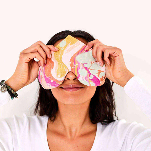 Heart-shaped eye love pillow with marbled organic cotton, perfect for relaxation and self-care.