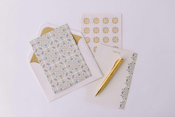 Folk Pattern Luxury Stationery Set in green and blue with gold accents, including writing sheets, envelopes, sealing stickers, and a gold pen.