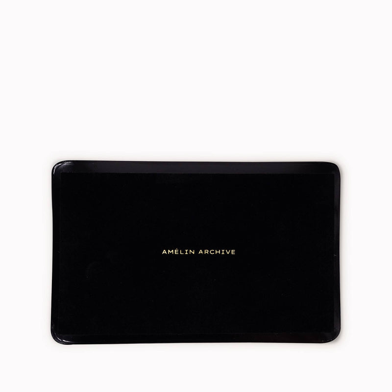 Glass tray with vintage calligraphy under smooth glass and black felt backing.