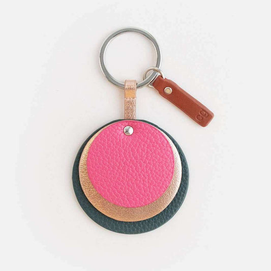 Green and pink layered disc-shaped keyring with leather look, usable as bag charm.
