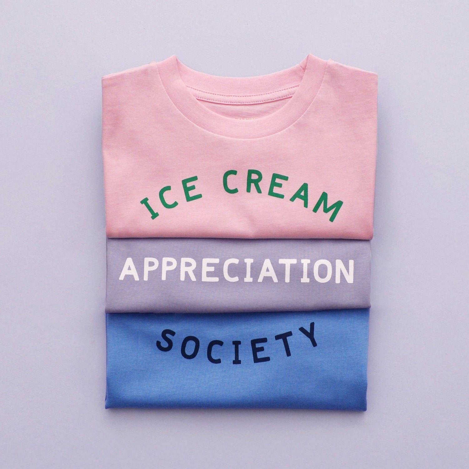 Women's pink t-shirt with "Ice Cream Appreciation Society" design in green text.