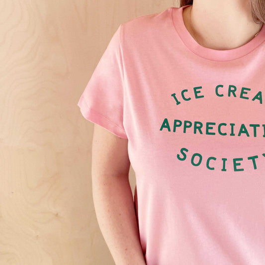 Women's pink t-shirt with "Ice Cream Appreciation Society" in green text.