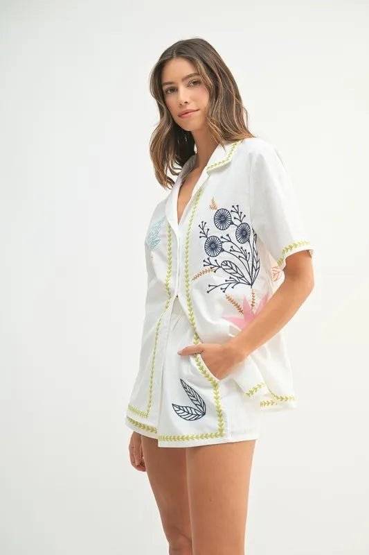 Embroidered button-down shirt and shorts set with floral accents, perfect for casual outings.