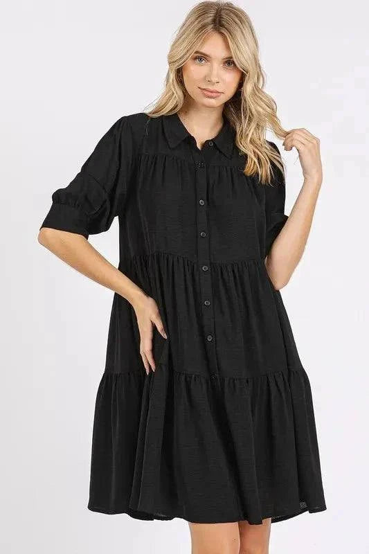 Button Detail Collared Neck Tiered Shirt Dress in black, featuring a classic collared neck and versatile tiered design for chic elegance.