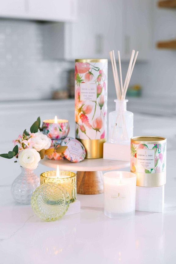 Morning Bloom 8oz Petite Shimmer in vibrant green on a stylish white surface with candles and floral decor.