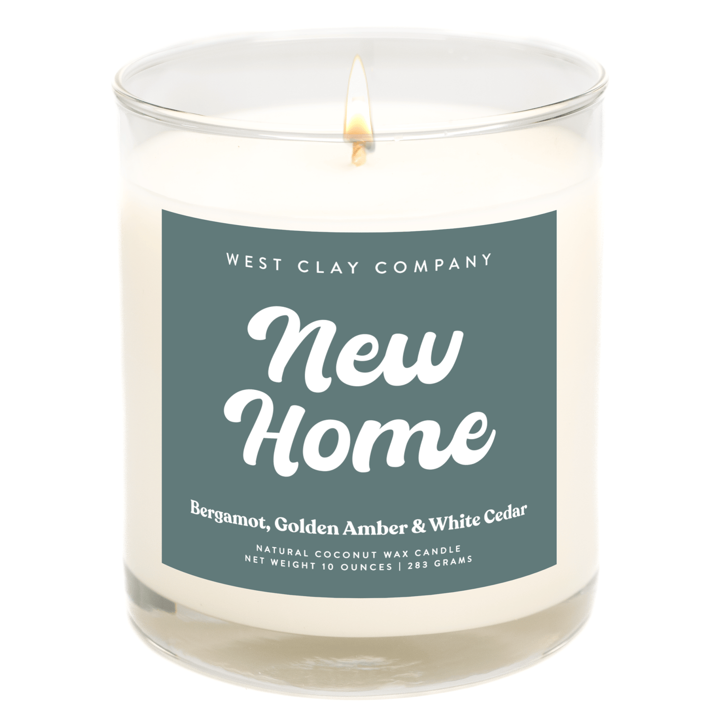 New Home Candle with Bergamot, Amber, and White Cedar scent in a glass jar.