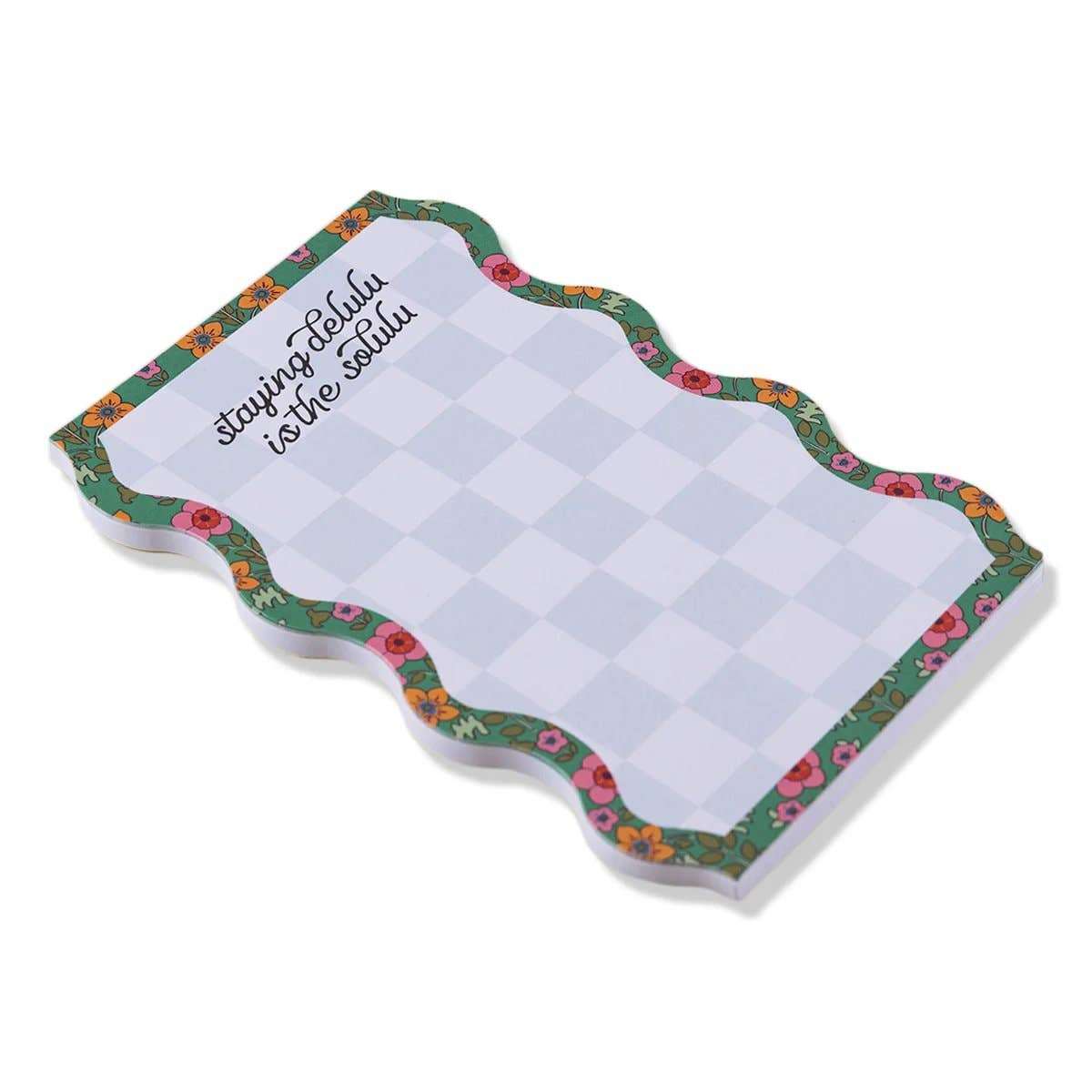 Colorful tear-off notepad with checkered design and floral border titled "Notepad - Delulu".