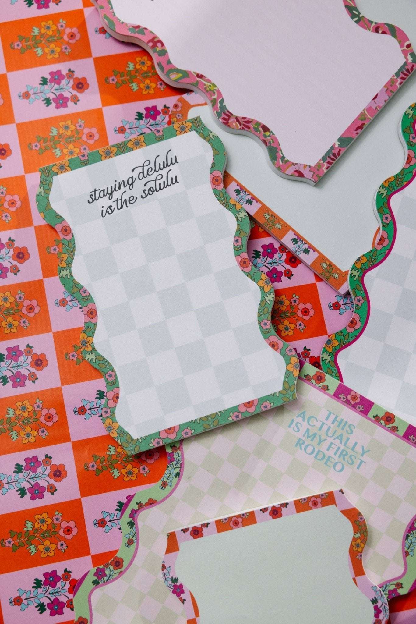 Colorful tear-off notepads with various designs, featuring the "Notepad - Delulu" style for managing tasks and notes.