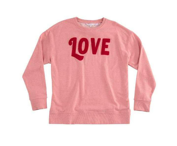 Pink “LOVE" sweatshirt with red lettering, cotton blend, machine washable.