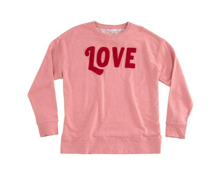 Pink “LOVE" sweatshirt with red lettering, cotton blend, machine washable.