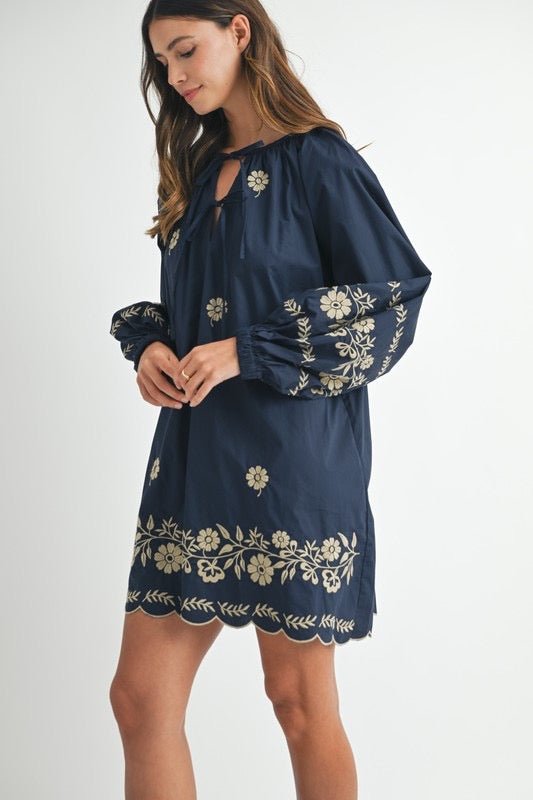 Embroidered long sleeve peasant mini dress with delicate embroidery.