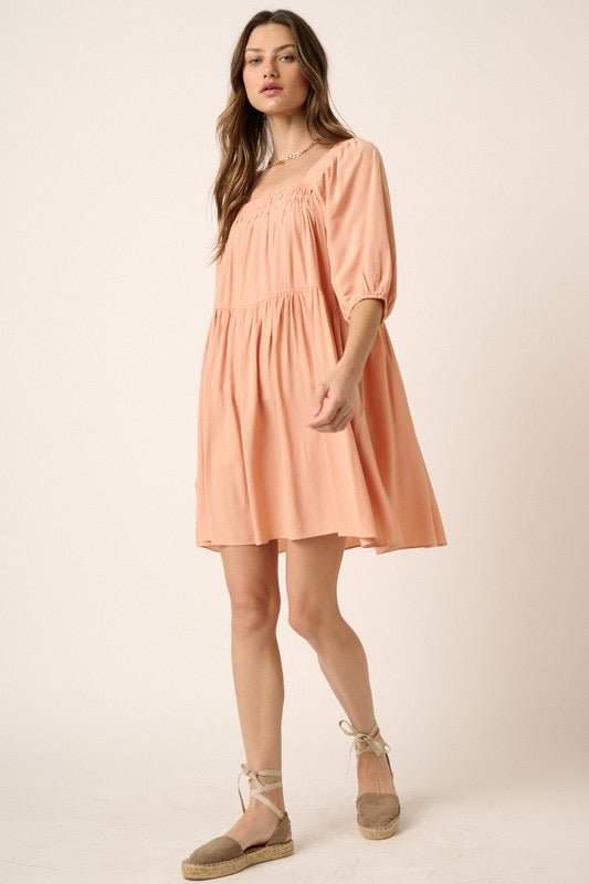 Pintuck Detail Tie Back Mini Dress in peach with pintuck texture and adjustable tie back, worn by a model.