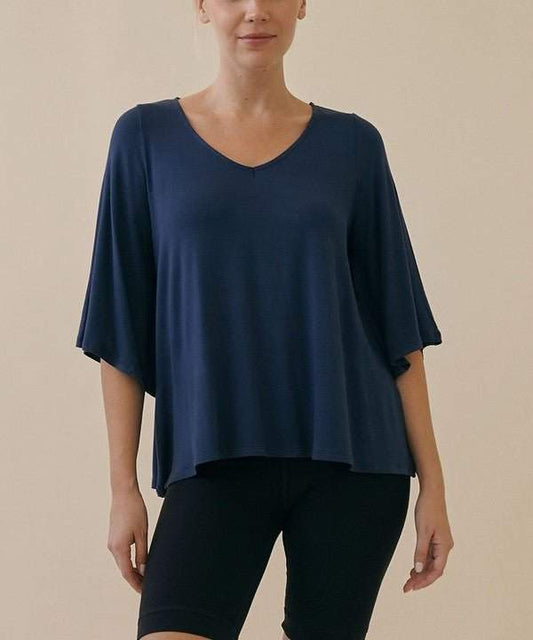 Studio Ko Bamboo Top with flared sleeves and high-low hem in navy blue.