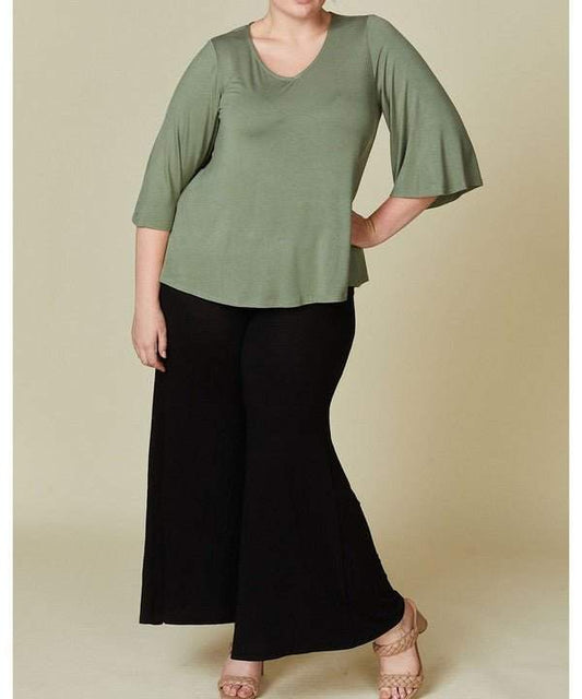 Studio Ko Bamboo Top in green, curvy fit with flared sleeves, high-low hem.