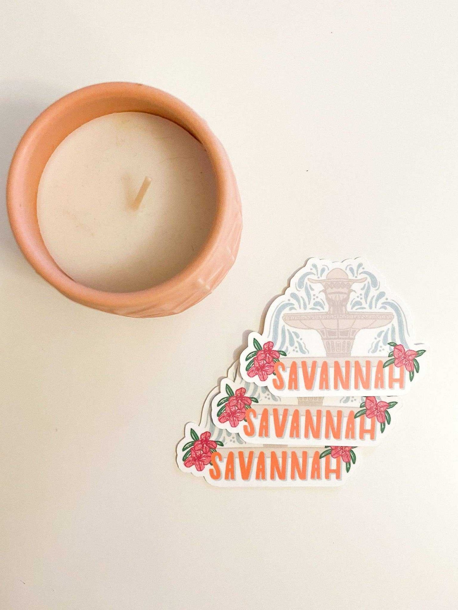 Sunglow Paper Co. Savannah Fountain Sticker with floral design next to a candle.