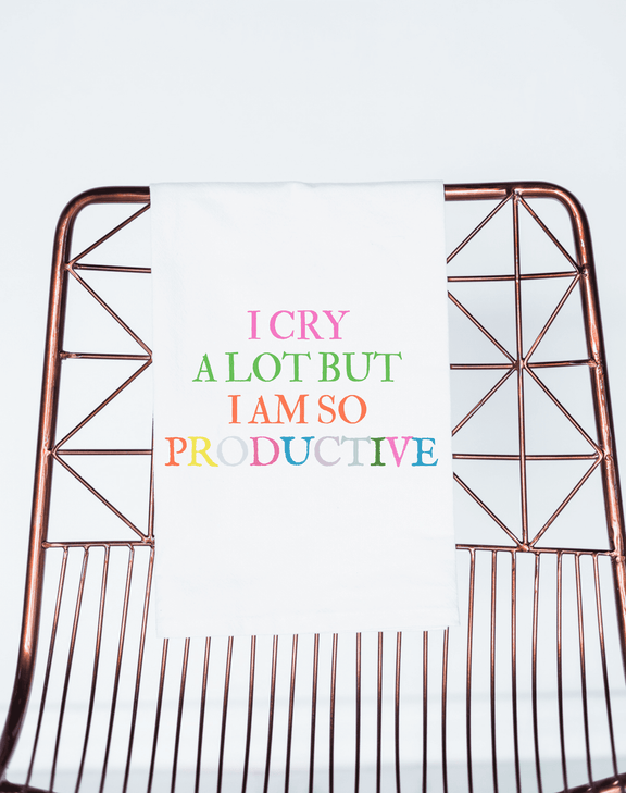 Taylor Swift inspired "I Cry A Lot But I am Productive" gift towel in colorful text on a chair.